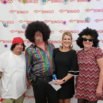 Four people posing at a Tejas Bingo event