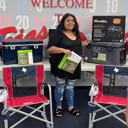 Woman displaying camping gear prize
