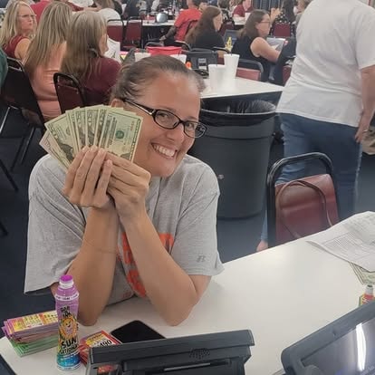 Woman holding cash at an event table