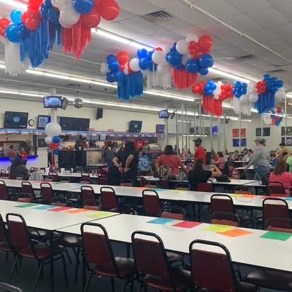 School cafeteria decorated with red, white, and blue balloons