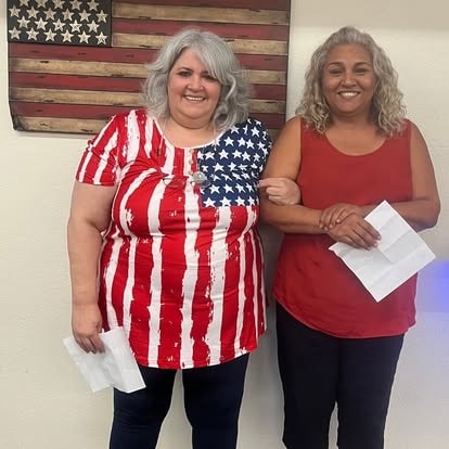 Two women holding American flags — patriotic event