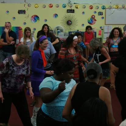 Group of people dancing in a classroom