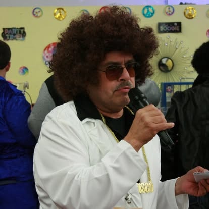 Man with afro speaking into a microphone