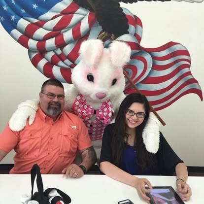 Couple posing with Easter Bunny mascot