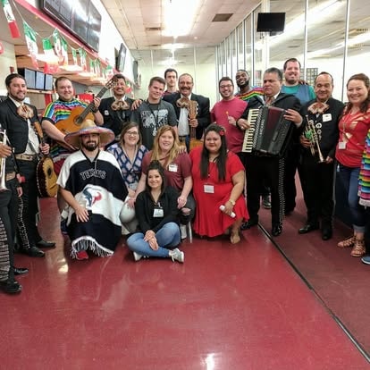Large group of musicians holding instruments indoors