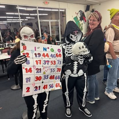 Woman with skeleton child holding a bingo card