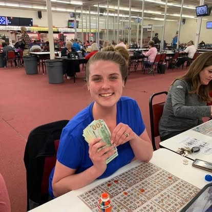 Woman holding cash at the bingo hall
