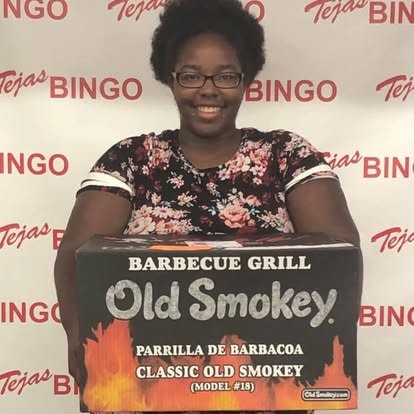 Woman holding an Old Smokey barbecue grill box prize
