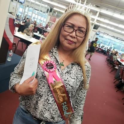 Woman holding an award certificate at an event