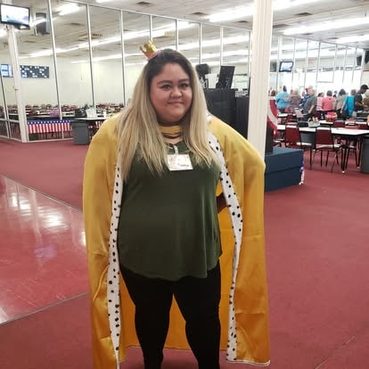 Woman wearing yellow cardigan in office space